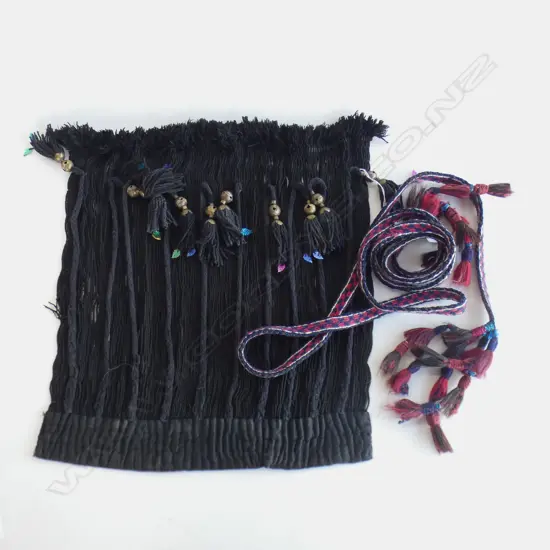 A black panel with tassels and long red/blue band with tassels